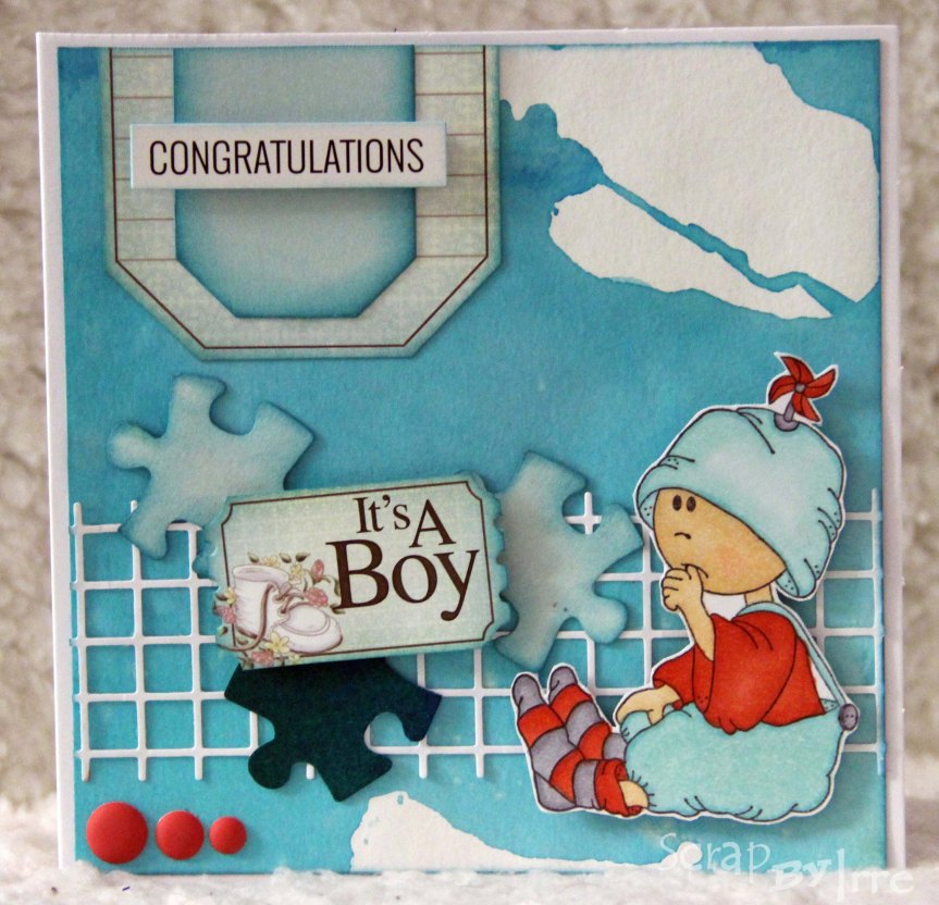 Baby card with puzzle pieces and a colored stamp